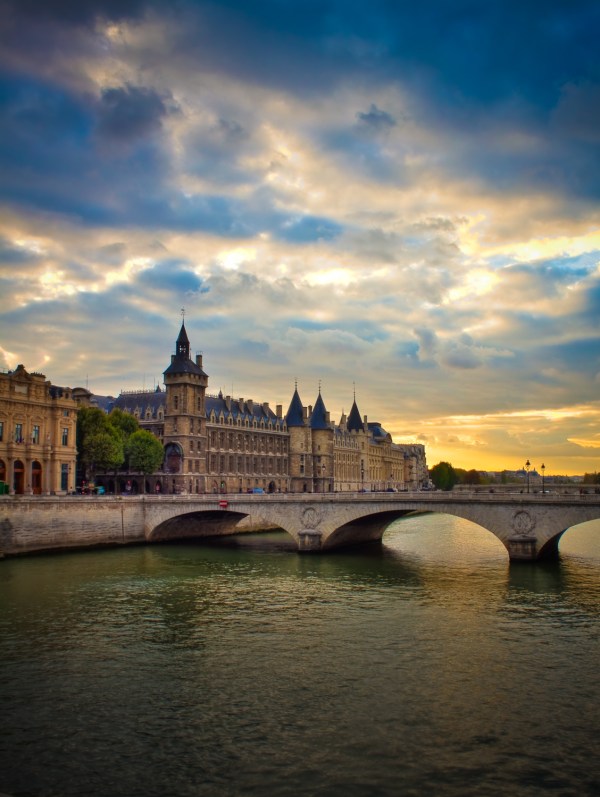 La Seine, Pont Notre Dame and La Conciergerie taken on amazing sunset in blue and yellow
